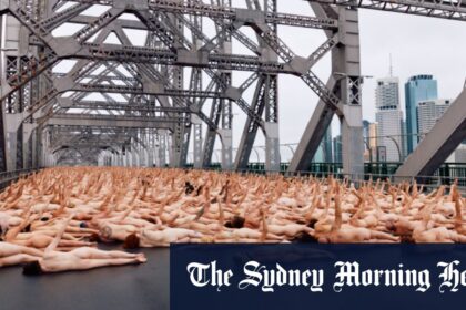 Nude awakening: Thousands flock to Story Bridge for dawn art shoot